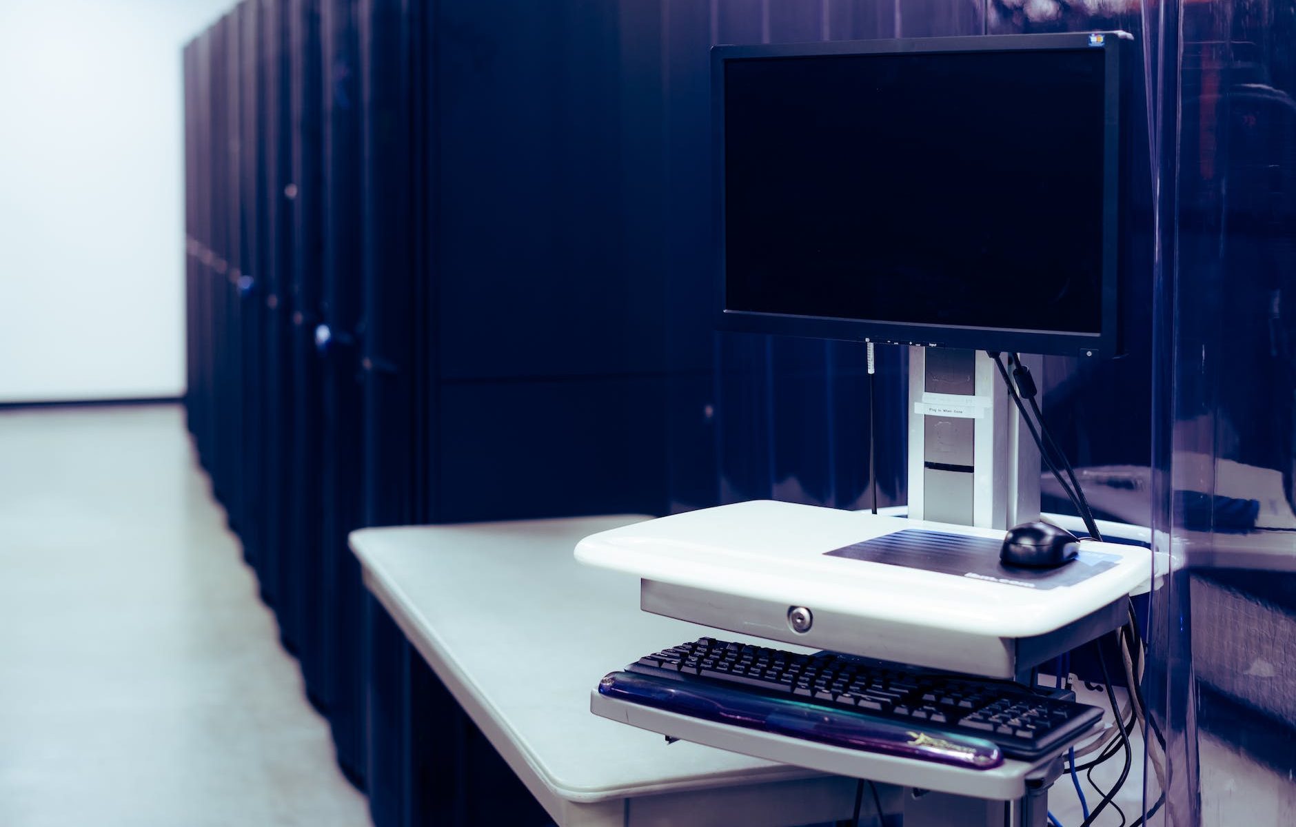 modern computer placed near server racks